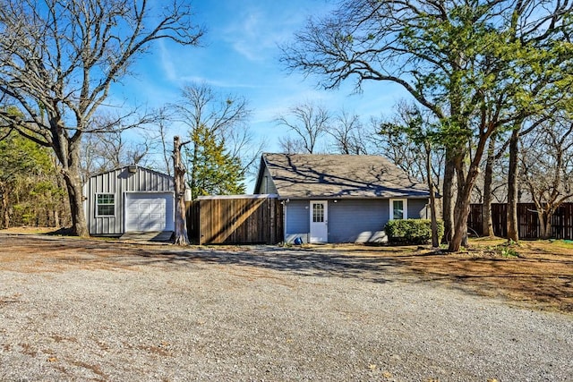 exterior space featuring an outbuilding and a garage