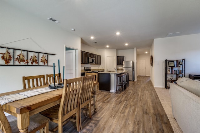 dining space with wood-type flooring