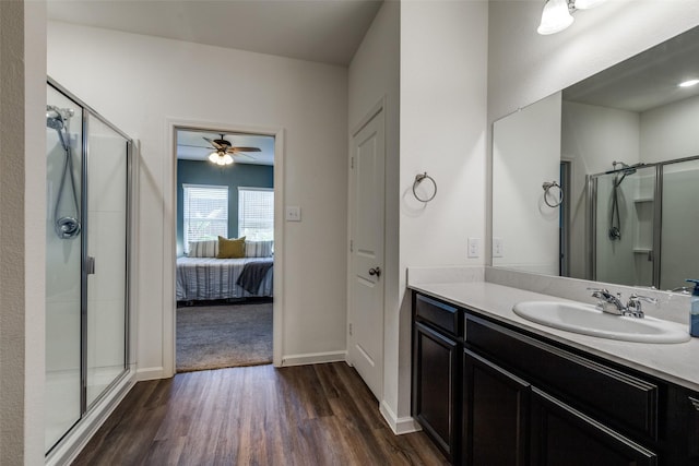 bathroom featuring an enclosed shower, vanity, hardwood / wood-style flooring, and ceiling fan