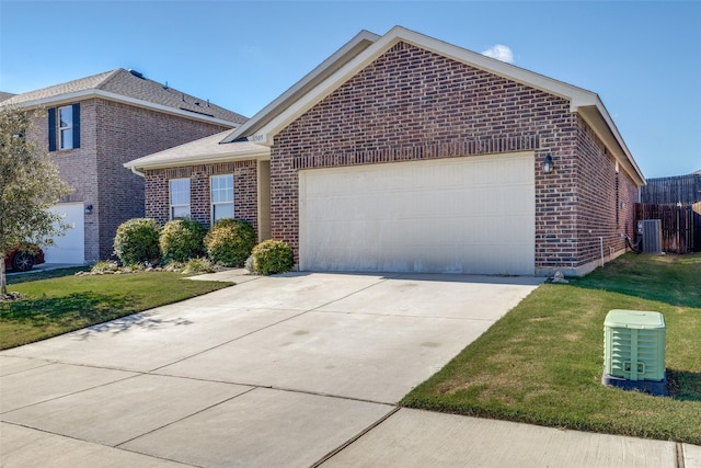 view of front of property featuring cooling unit, a garage, and a front lawn