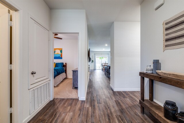 corridor featuring dark hardwood / wood-style floors