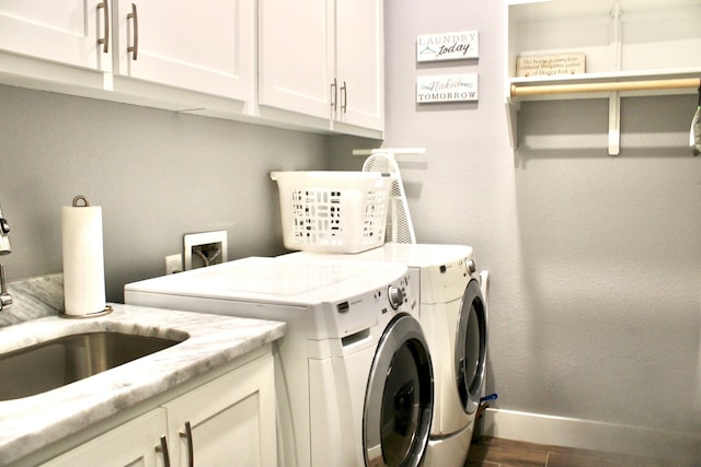 washroom featuring cabinets, washing machine and dryer, dark hardwood / wood-style floors, and sink