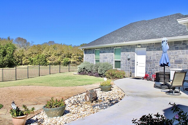 view of yard with fence and a patio