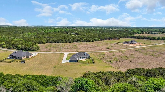 birds eye view of property featuring a rural view and a forest view