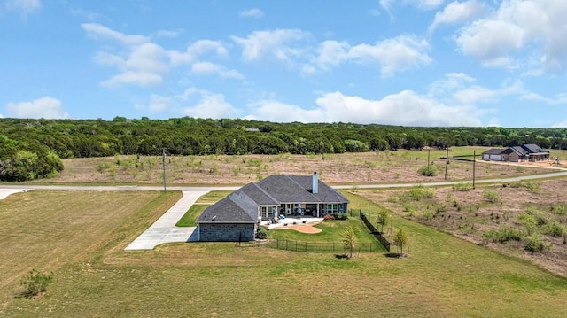 drone / aerial view featuring a forest view and a rural view