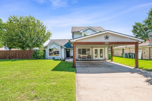 view of front of property featuring french doors, a front yard, and a carport