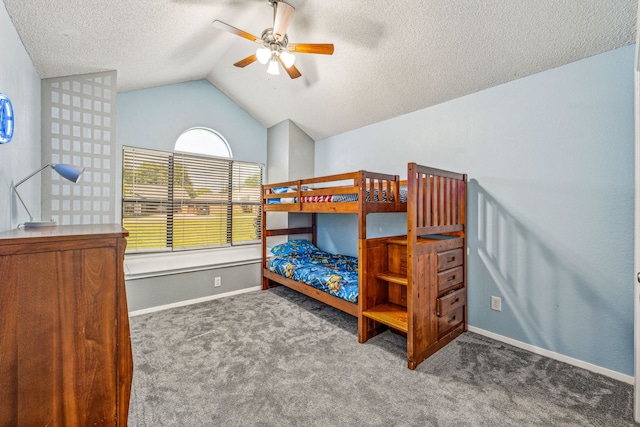 bedroom featuring dark carpet, a textured ceiling, vaulted ceiling, and ceiling fan