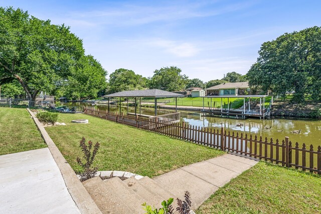 view of yard with a boat dock and a water view