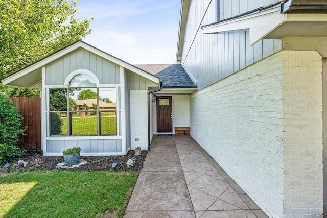 entrance to property with a yard