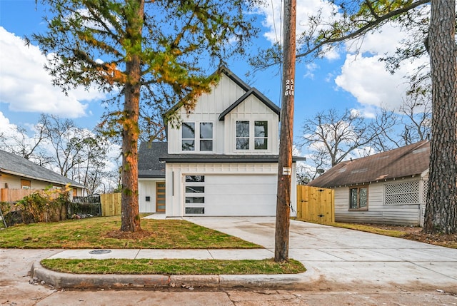 view of front of property featuring a front yard and a garage