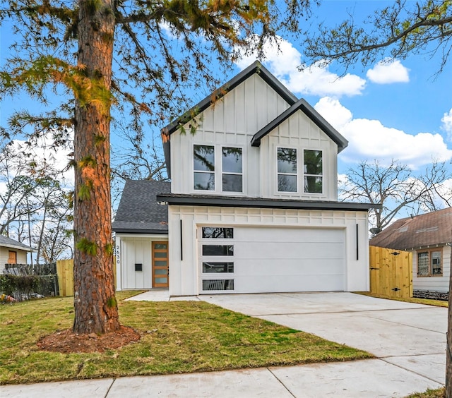 view of front of house with a front lawn and a garage