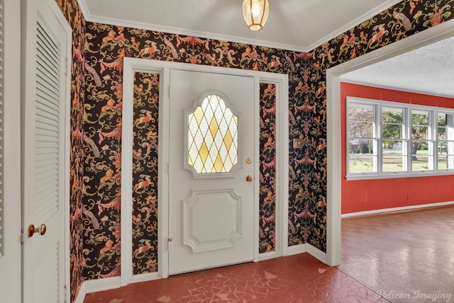 foyer entrance with a textured ceiling and ornamental molding