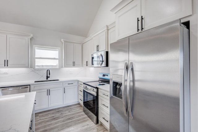 kitchen featuring white cabinets, sink, and appliances with stainless steel finishes