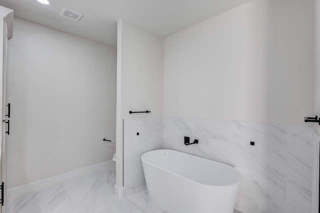 bathroom featuring tile walls and a bathing tub