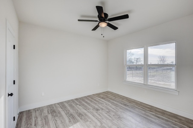 empty room with ceiling fan and light wood-type flooring