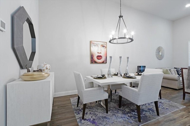 dining space featuring dark hardwood / wood-style floors and a chandelier