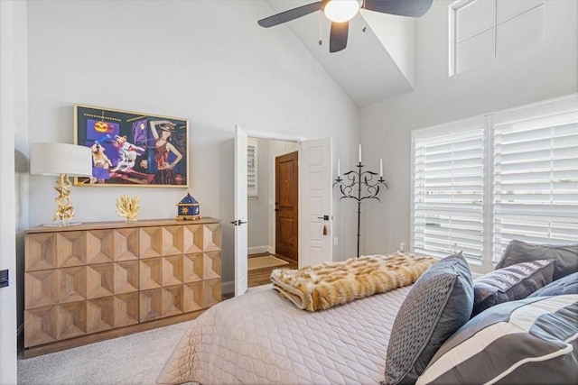 bedroom with ceiling fan, high vaulted ceiling, and carpet