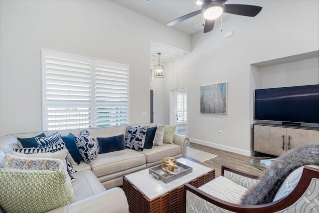 living room featuring ceiling fan, hardwood / wood-style flooring, and a healthy amount of sunlight