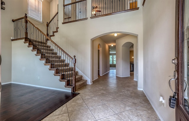 foyer entrance featuring a high ceiling and light tile patterned flooring