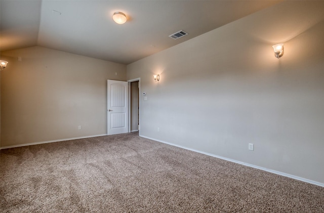 empty room with carpet and vaulted ceiling