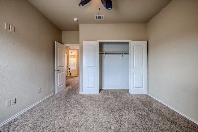 unfurnished bedroom with ceiling fan, a closet, and carpet