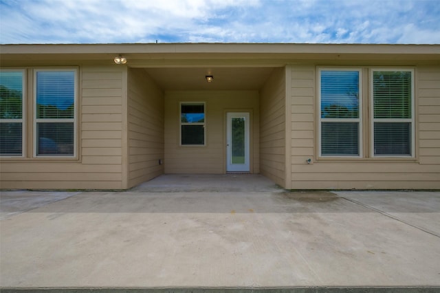 doorway to property with a patio