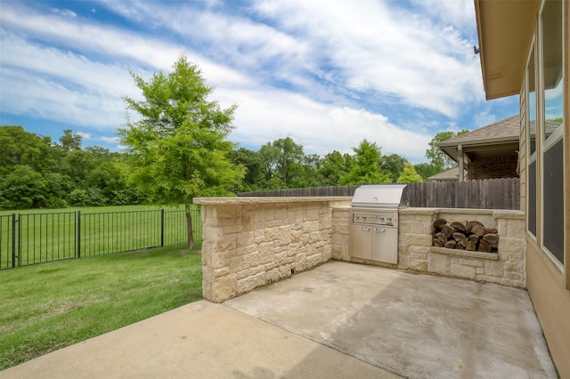 view of patio with area for grilling and an outdoor kitchen