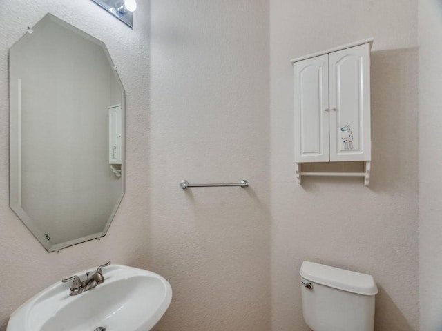 bathroom with toilet and sink