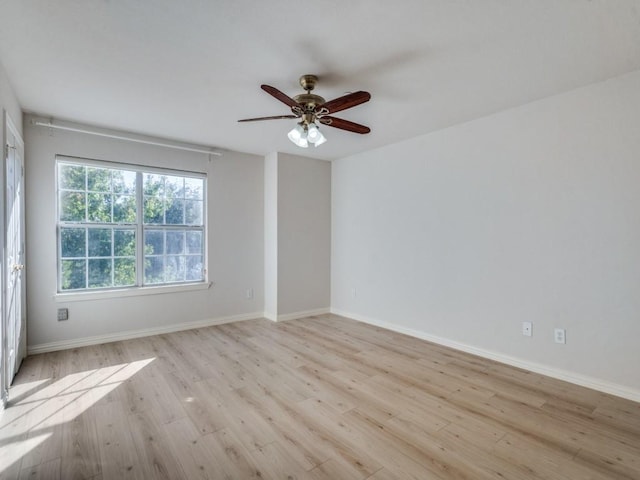 spare room featuring light hardwood / wood-style flooring and ceiling fan