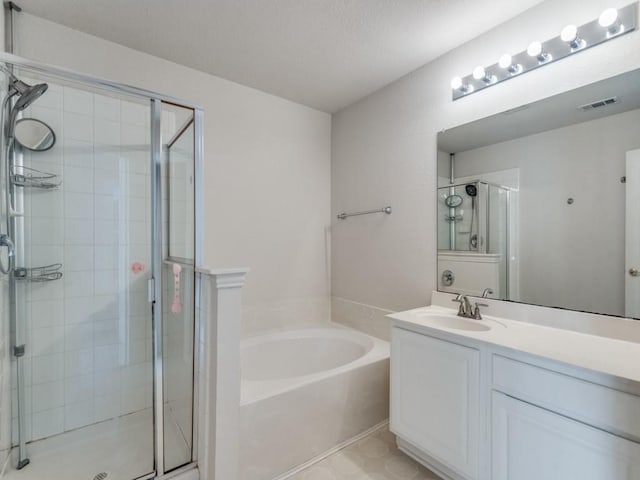 bathroom featuring shower with separate bathtub and vanity