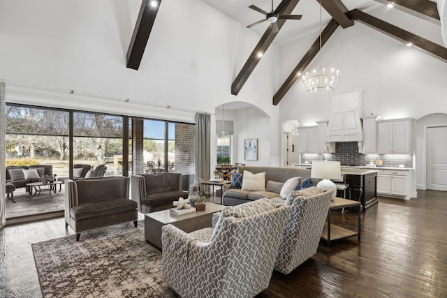 living room featuring beamed ceiling, dark hardwood / wood-style flooring, high vaulted ceiling, and ceiling fan with notable chandelier