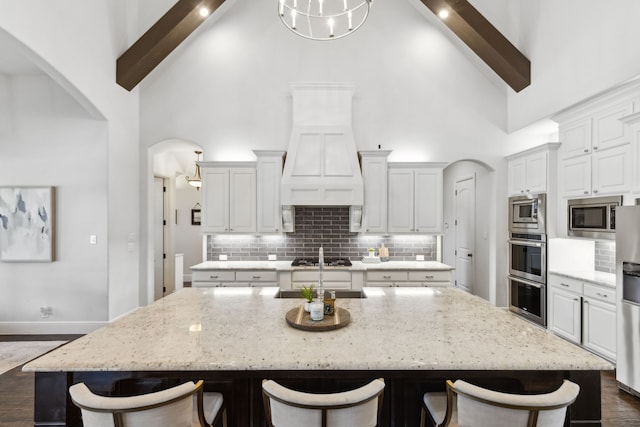 kitchen with a large island, high vaulted ceiling, and beamed ceiling