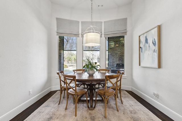 dining area with dark hardwood / wood-style flooring