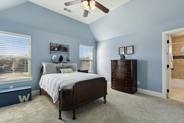 carpeted bedroom featuring lofted ceiling, ensuite bathroom, and ceiling fan