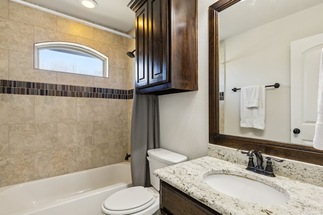 full bathroom featuring toilet, vanity, and tiled shower / bath