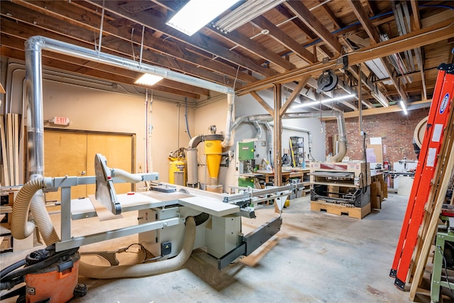 basement with a workshop area and brick wall