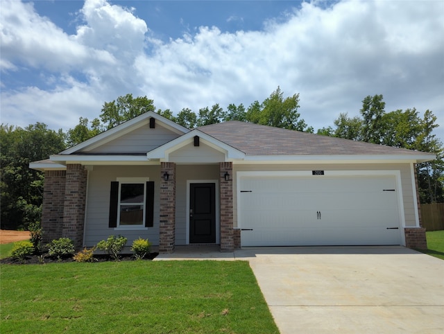 view of front of property with a front lawn and a garage