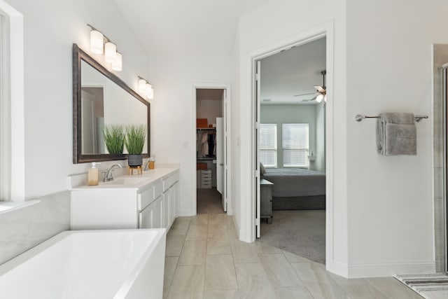 bathroom featuring a tub to relax in, vanity, and ceiling fan