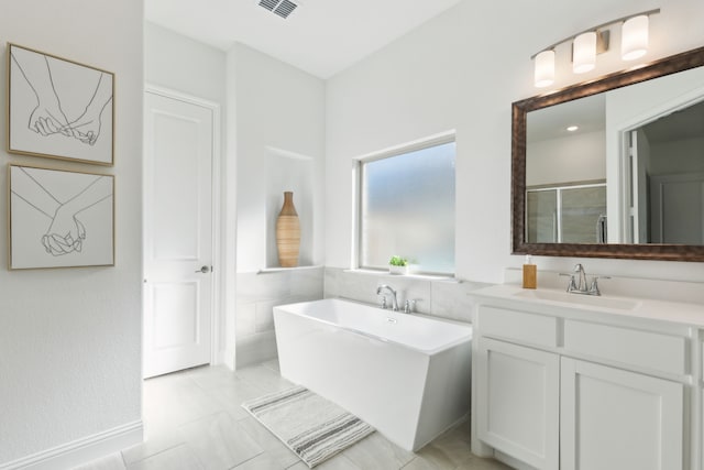 bathroom featuring tile patterned flooring, plus walk in shower, and vanity