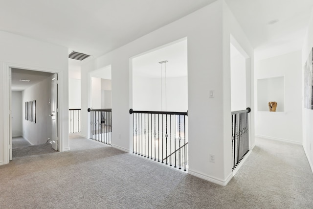 corridor featuring light colored carpet