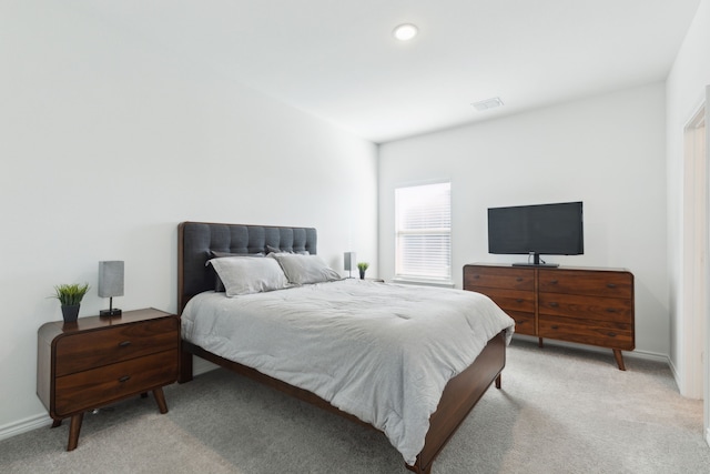 bedroom featuring light colored carpet