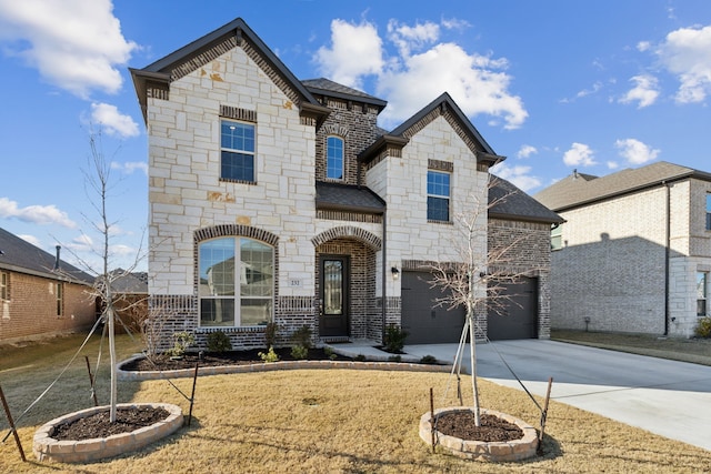 view of front of home with a front yard and a garage