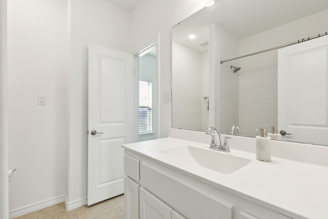 bathroom featuring tile patterned flooring, walk in shower, and vanity