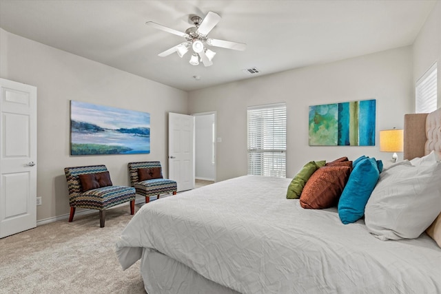 bedroom featuring ceiling fan and light carpet