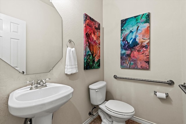 bathroom featuring toilet and sink