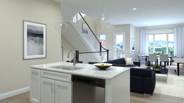 kitchen featuring sink, stainless steel dishwasher, a center island with sink, white cabinets, and light wood-type flooring