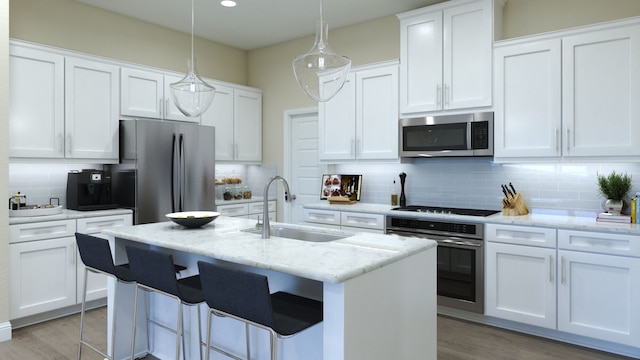 kitchen featuring pendant lighting, white cabinets, sink, decorative backsplash, and stainless steel appliances