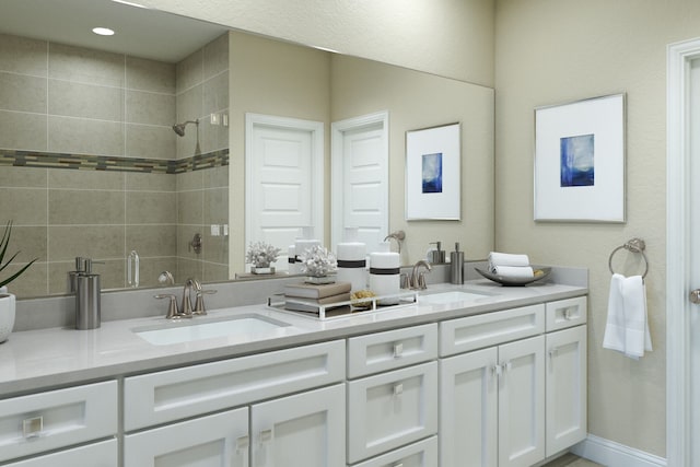 bathroom featuring tiled shower and vanity