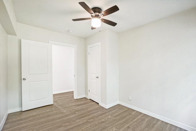 unfurnished bedroom with ceiling fan and light wood-type flooring