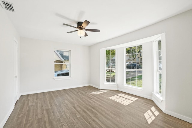 empty room with ceiling fan and wood-type flooring